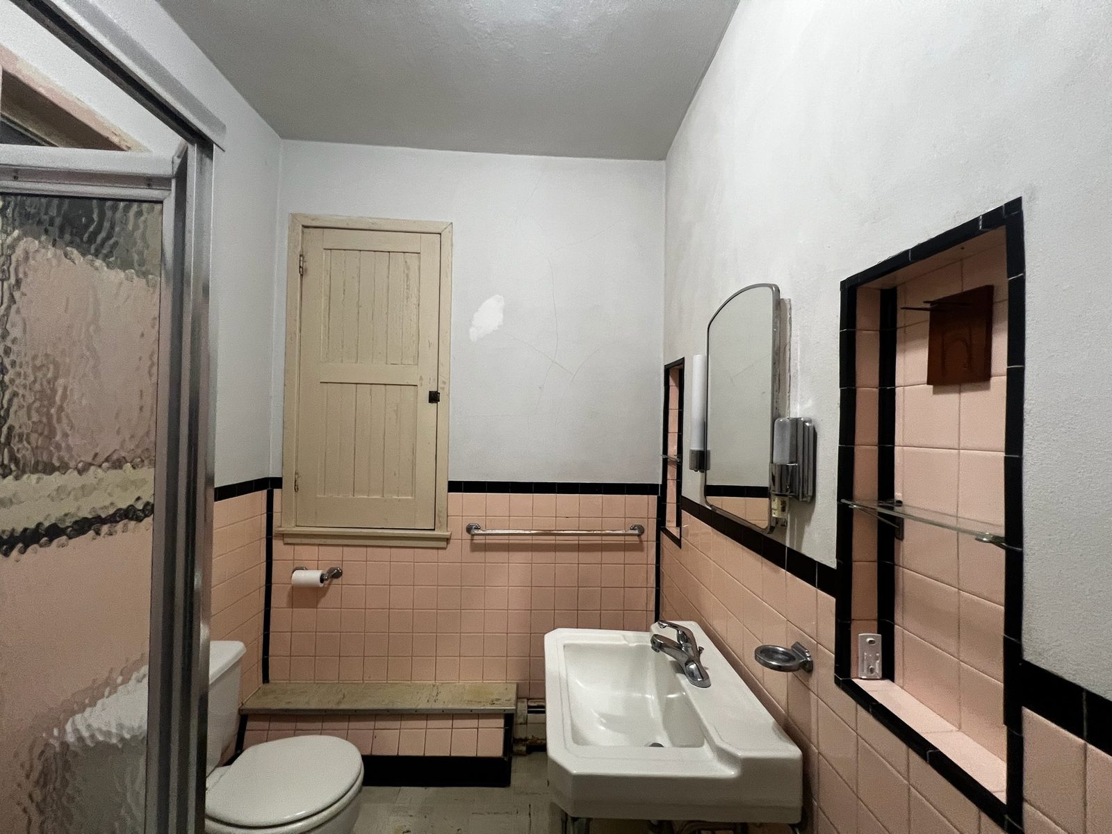 Bathroom before renovation with dated peach tile