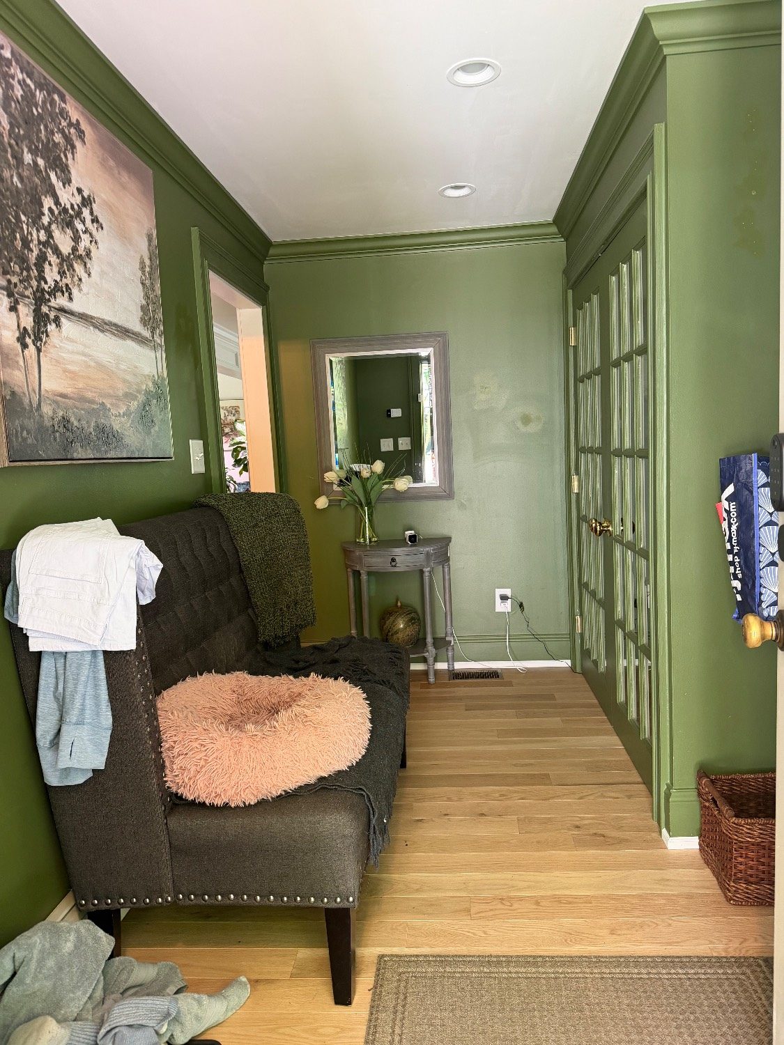 Cluttered green hallway before styling